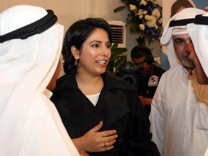 Kuwaiti Reham al-Jlewe (C), a candidate in Kuwait's upcoming parliamentary elections, welcomes her guests at her election campaign tent in Kuwait City (Yasser al-Zayyat / AFP)