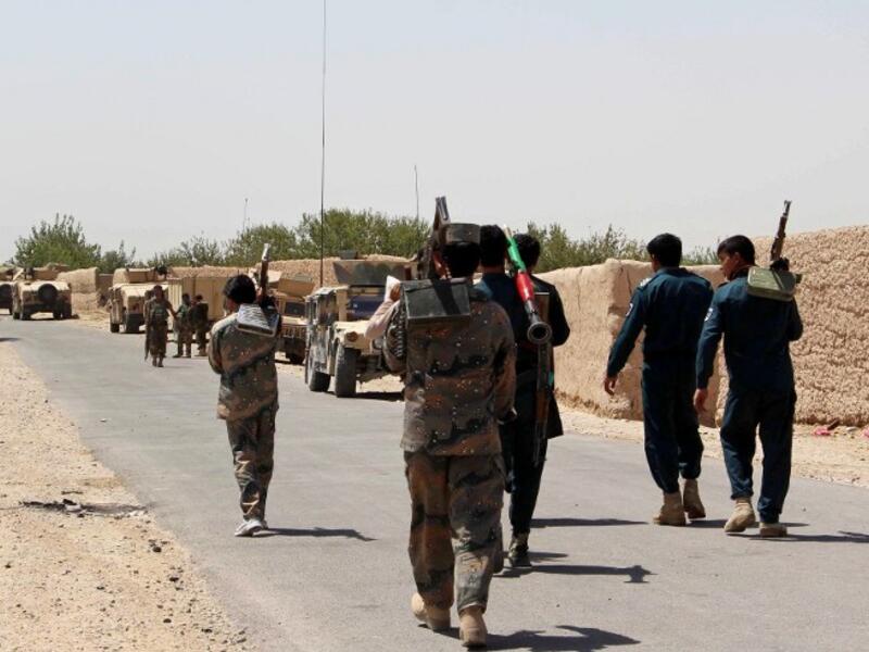 Afghan security forces walk down a major road in the Helmand province. (AFP/File)