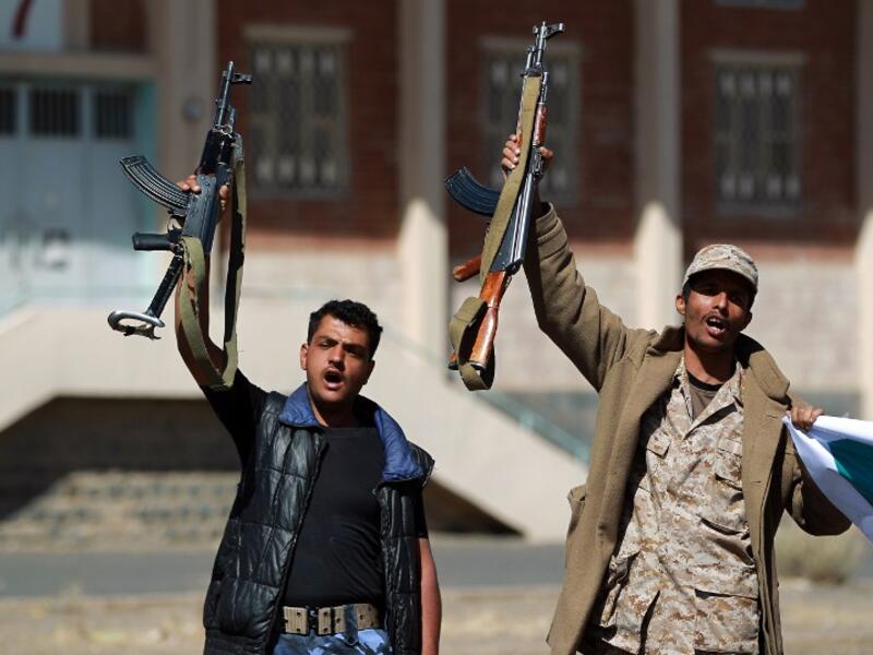 Armed Yemeni members of the Houthi movement shout slogans as they take part in a demonstration in Sanaa on February 4, 2015. (AFP/Mohammed Huwais)