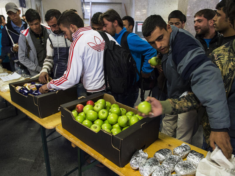 Refugees receive food in Germany, and Alex Assali wanted to give back to the German people for their hospitality. (AFP/File)