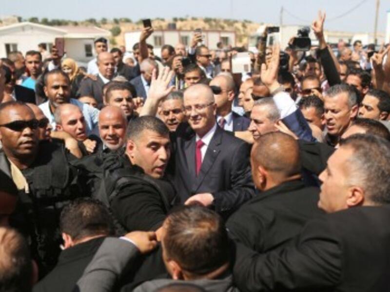 Palestinian Authority Prime Minister Rami Hamdallah is surrounded by security (AFP/File Photo)	