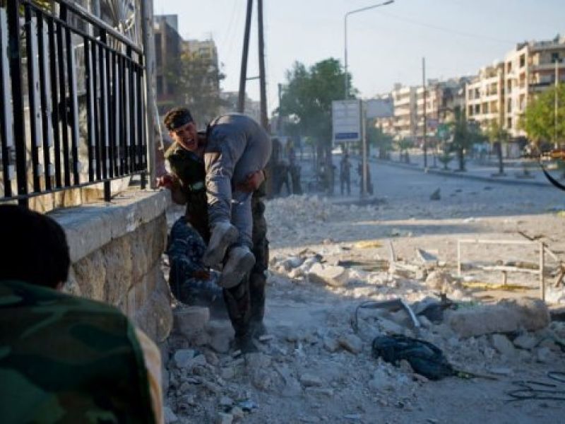 A man carrying a wounded friend after airstrikes in Idlib. (AFP/File)