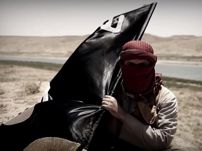 A Daesh militant carries his flag. (AFP/File)