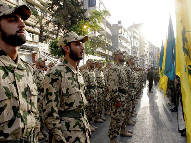 Members of Lebanon's Shiite movement Hezbollah attend the funeral fighter of Mohamed Choucair, on May 26, 2015, in a southern suburb of the Lebanese capital Beirut after he was killed in combat alongside Syrian government forces in the Qalamun region. (AFP/STR)