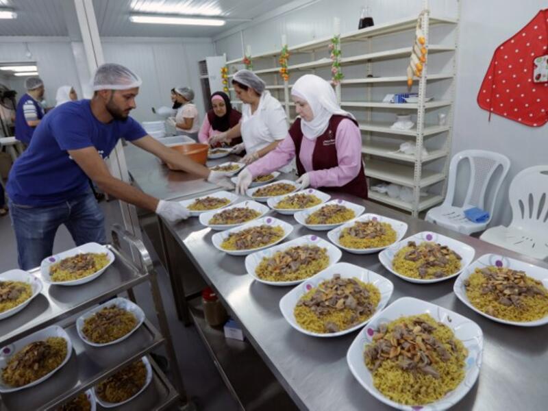 Lebanese and Syrians prepare dishes for an "Iftar" (fast breaking) dinner in the Lebanese capital Beirut on June 8, 2017. (Anwar Amro/AFP)