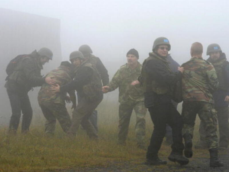 Apprentice chemical weapons inspectors of the United Nations and extras take part in an exercise during the education of OPCW inspectors at the German armed forces. [Getty Images]