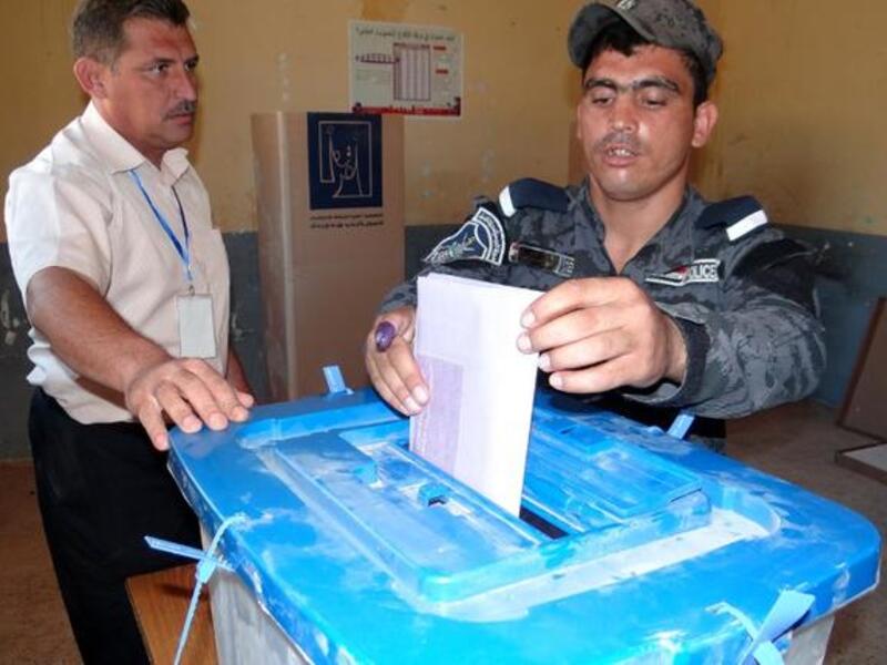An Iraqi policeman casts his ballot in Ramadi on June 17, 2013 as security forces vote in provincial polls ahead of the rest of Iraqis in the Anbar province. Iraq held provincial elections in April except in six provinces, including Anbar and Nineveh, where polls were delayed because authorities said security could not be guaranteed (Azhar Shallal / AFP)