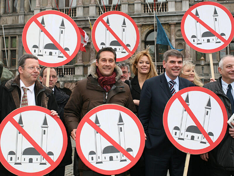 Members of several European right wing parties pose with signs, after the presentation of their organisation of 'Cities against Islamisation' in Antwerp. (AFP/Jorge Dirkx) 