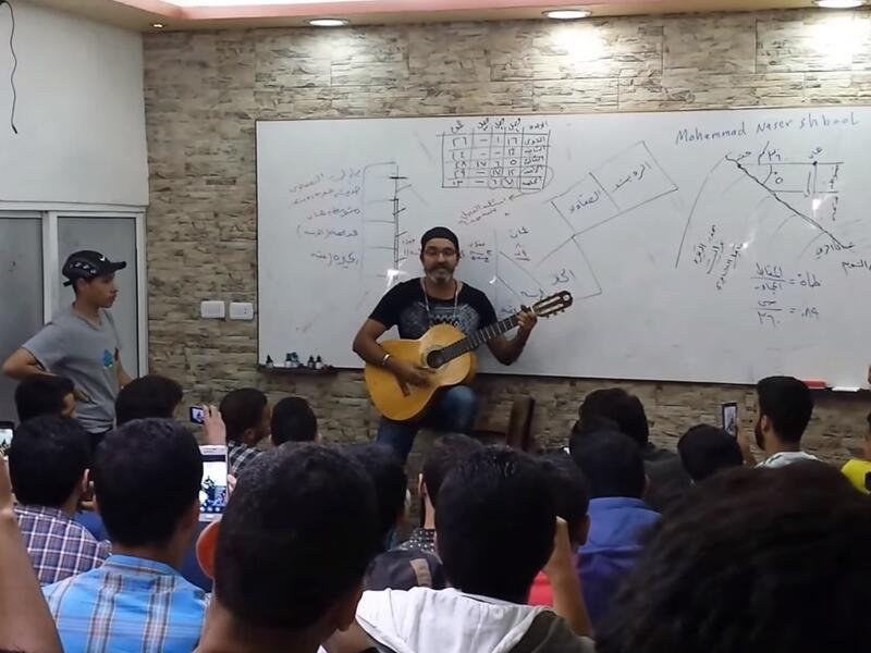 Whether he is dancing, playing Oud or guitar, Shbool is always full of energy while teaching (Youtube)