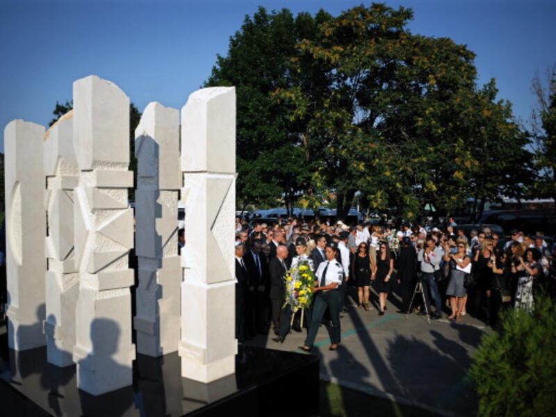Relatives and officials pay respect on July 18, 2013 to a memorial dedicated to the five Israeli and one Bulgarian victims of a suicide blast which targeted on July 18, 2012 a bus of Israeli tourists at Burgas airport, southeast Bulgaria. A year after, Bulgaria is struggling to identify the attacker or confirm his suspected links to Hezbollah or Iran. (NIKOLAY DOYCHINOV/AFP/Getty Images)