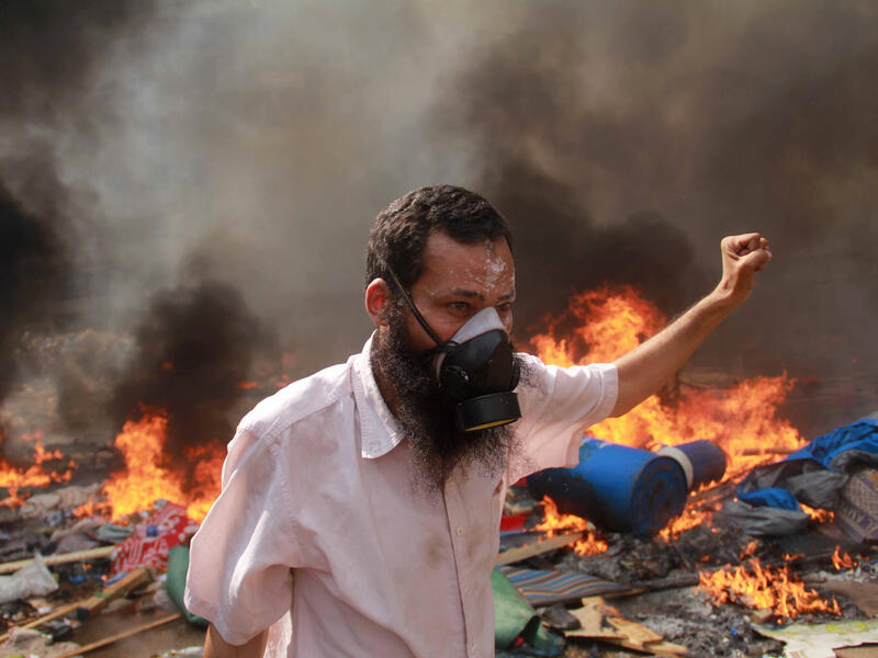 A supporter of the Muslim Brotherhood and Egypt's ousted president Mohamed Morsi gestures during clashes with police in Cairo (AFP/MOSAAB EL-SHAMY)