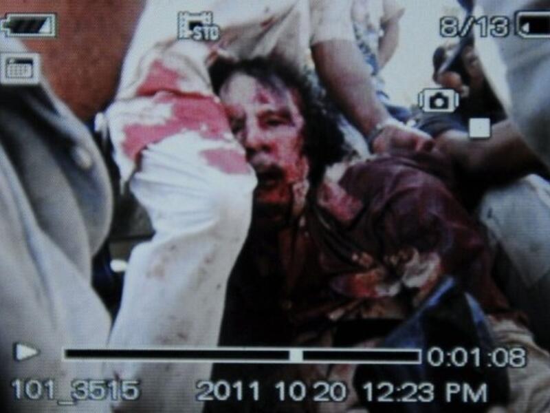 An image captured off a cellular phone camera shows the arrest of Libya's strongman Moammer Gaddafi.