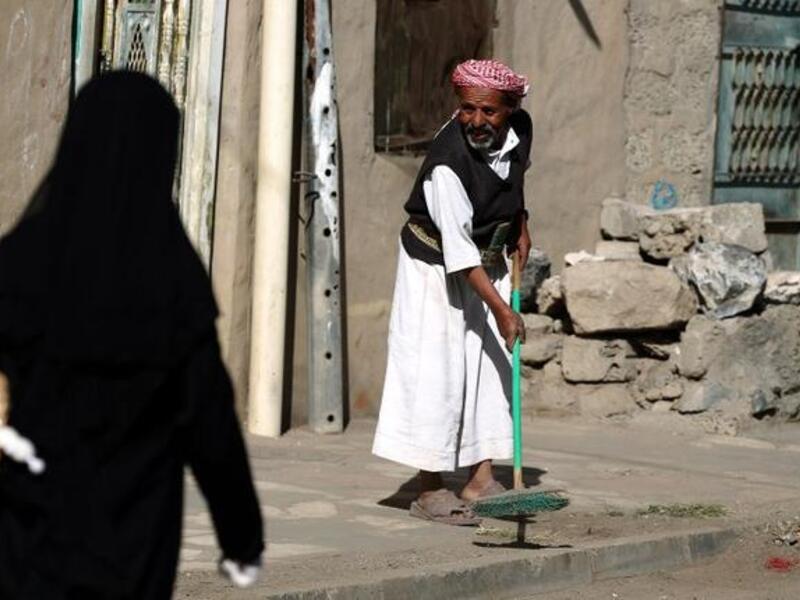 A Yemeni man sweeps a street during the "Sharik (participate), My contribution builds Yemen" cleaning campaign in the capital. (AFP PHOTO/ MOHAMMED HUWAIS)