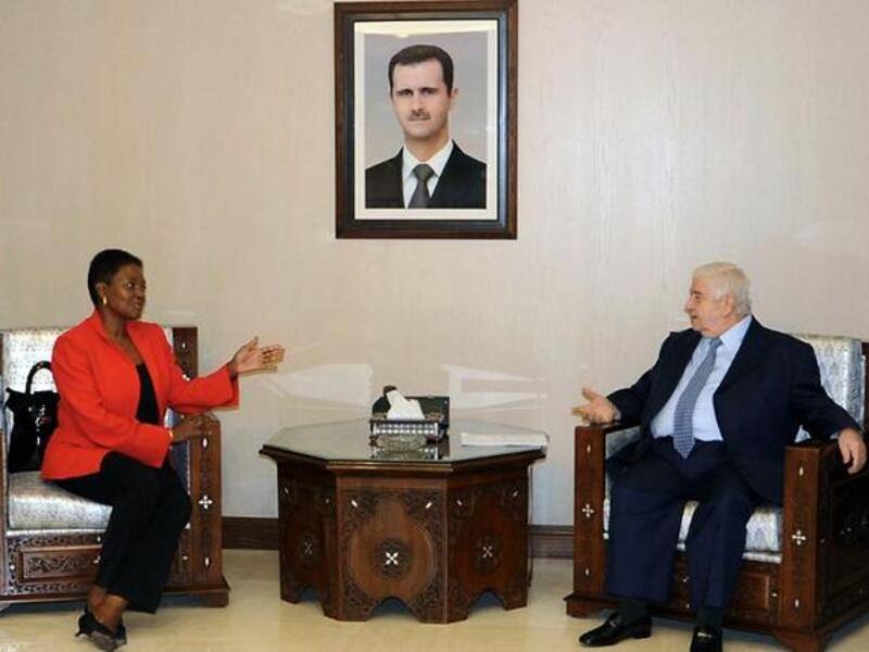 Syrian Foreign Minister Walid Muallem (R) speaks with UN humanitarian chief Valerie Amos during a meeting in Damascus on December Saturday. Muallem called on the United Nations to intervene and lift sanctions imposed on Syria, SANA reported. (AFP PHOTO/HO/SANA) 