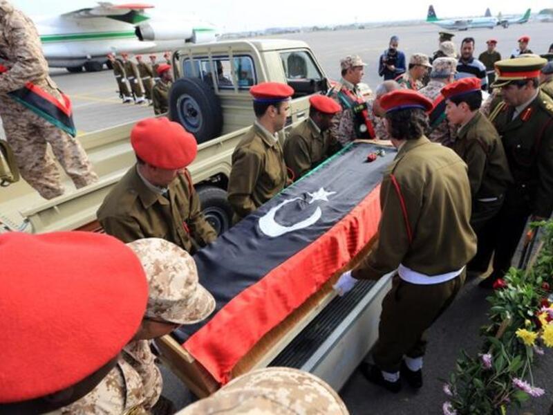 Libyan army soldiers carry the coffin of one of two soldiers killed in action in the oasis town of Bani Walid during a memorial service at Mitiga Airport, in Tripoli, on Sunday. (AFP PHOTO/MAHMUD TURKIA)