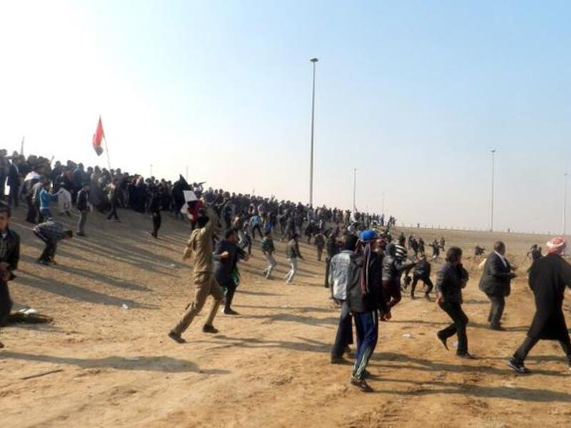 Iraqis throw stones after protestors attacked Iraq's deputy prime minister Saleh al-Mutlak on Sunday. (AFP)