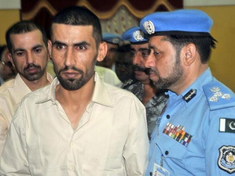 Hassan Mazawdeh and Qasem Sarhan walk past UN comrades upon their arrival in Khartoum following their release from captivity on Wednesday. (AFP PHOTO/EBRAHIM HAMID)