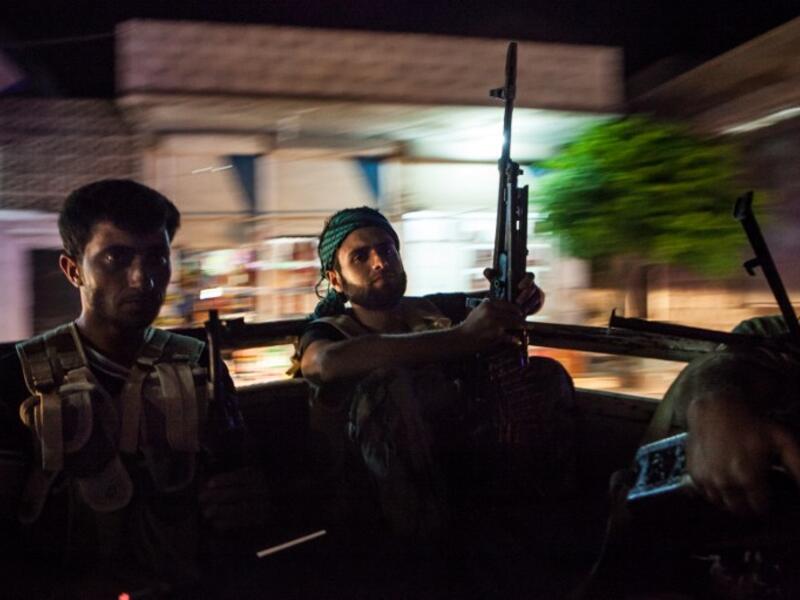 Syrian rebels head to the town of Bsankol in the northwestern province of Idlib to join comrades fighting regime forces for the control of the highway that connects Idlib with Latakia on July 11, 2013. (AFP PHOTO/DANIEL LEAL-OLIVAS)