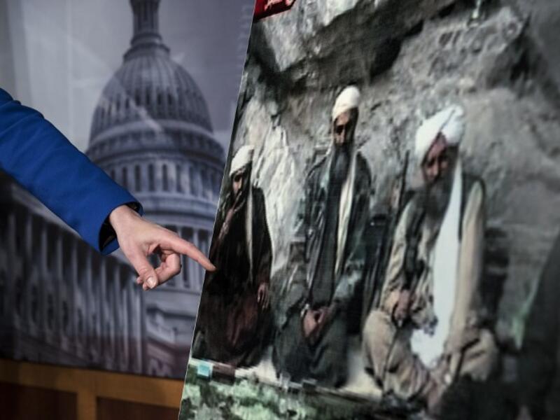 US Senator Kelly Ayotte points to a photo of Sulaiman Abu Ghaith (L) during a press conference on Capitol Hill in Washington, DC. (AFP PHOTO/Brendan SMIALOWSKI)