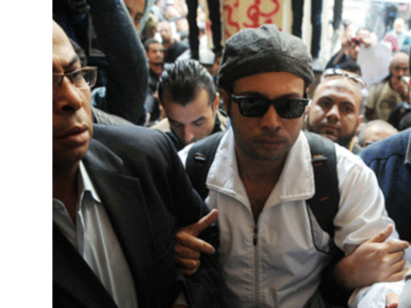 Mohamed Adel is seen with Ahmed Maher , founder and former leader of the "April 6" movement, when Maher turned himself in at Abddein court in Cairo, November 30, 2013.