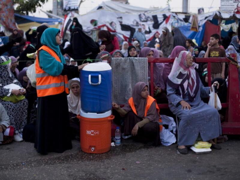 Supporters of deposed Egyptian President Mohammed Morsi wait prior to the 'iftar' fast-breaking meal at a sit-in protest at the Rabaa al Adweya Mosque in the Nasr City district on July 28, 2013 in Cairo. (Getty images)