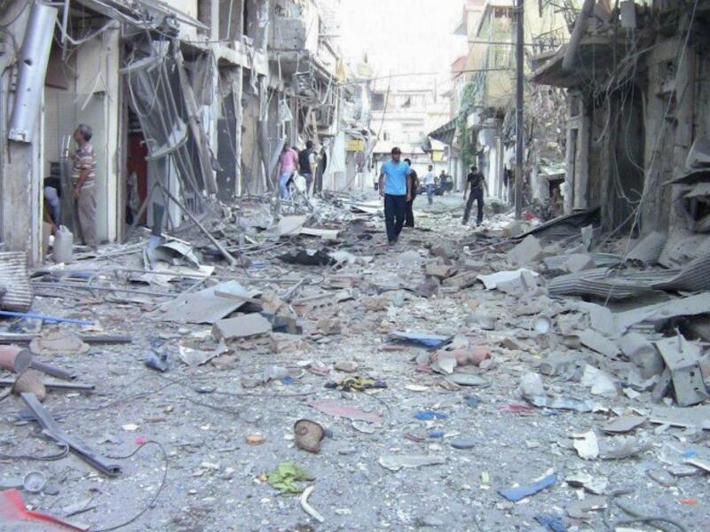 Residents investigate the damage after an alleged shelling attack in Damascus on August 8 2012 (AFP Photo)