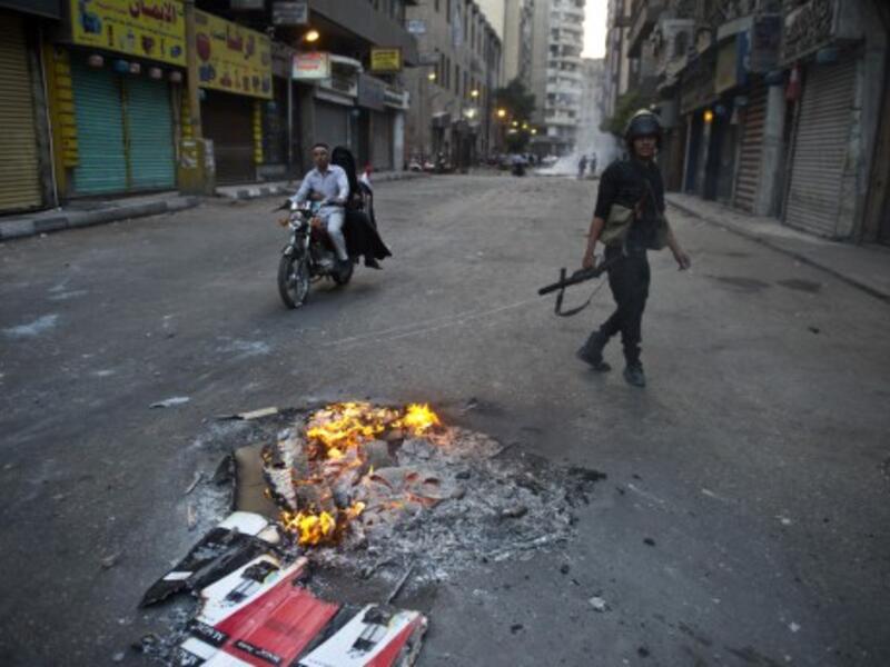 An Egyptian riot policeman takes position in Al Jumhuria street in downtown Cairo during clashes with Muslim Brotherhood supporters of Egypt's ousted Islamist president Mohamed Morsi on October 6, 2013. (AFP)