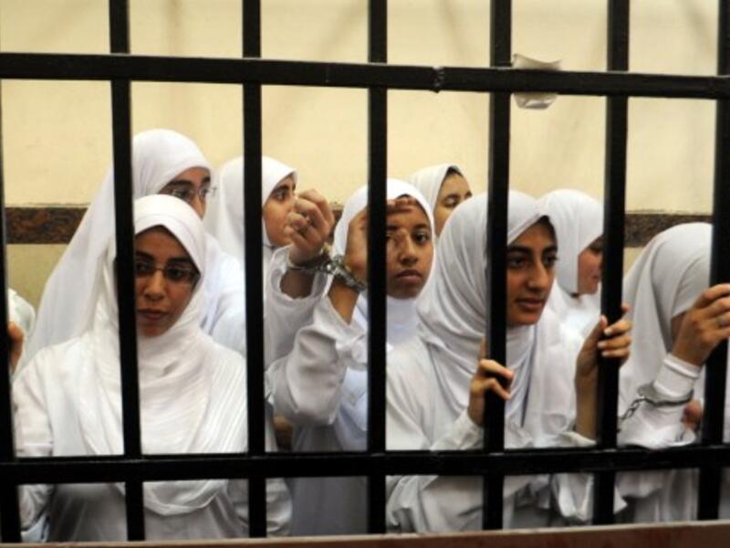 Female members of the Muslim Brotherhood are seen during their trial in the Egyptian city of Alexandria on November 27, 2013. Seven of the 21 arrested are aged between 15-17. (AFP)