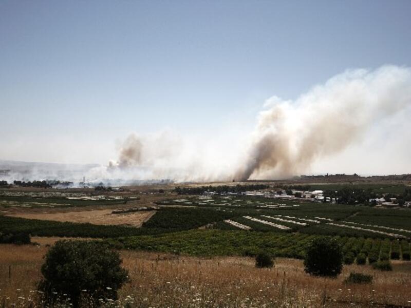 Smoke billows during clashes between Syrian rebels and forces loyal to the regime near the Quneitra crossing in the Golan Heights on Thursday. AFP Photo