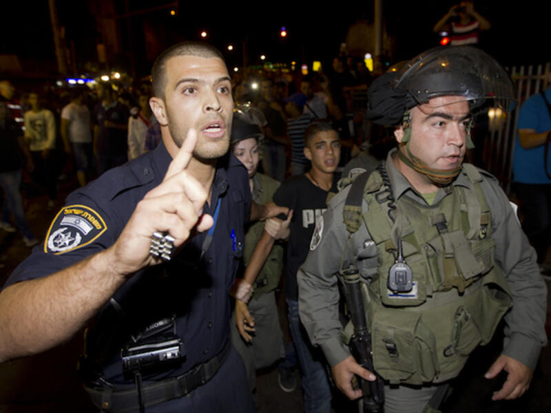 Israeli security forces arrest a Palestinian protestor in Jerusalem during a demonstration against the Israeli government's plans to relocate Bedouins in the Negev desert. (Source: AFP/AHMAD GHARABLI)