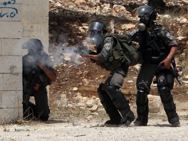 Israeli security forces fire tear gas during clashes with Palestinian protesters following a protest against the expropriation of Palestinian land by Israel. AFP Photo