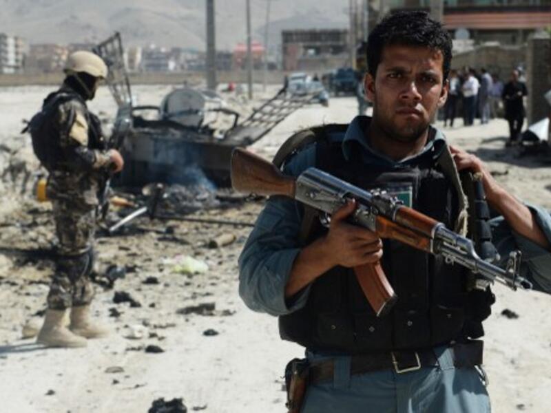 Afghan security forces stand guard at the site of a suicide attack near Kabul military airport in Kabul on Monday. AFP photo