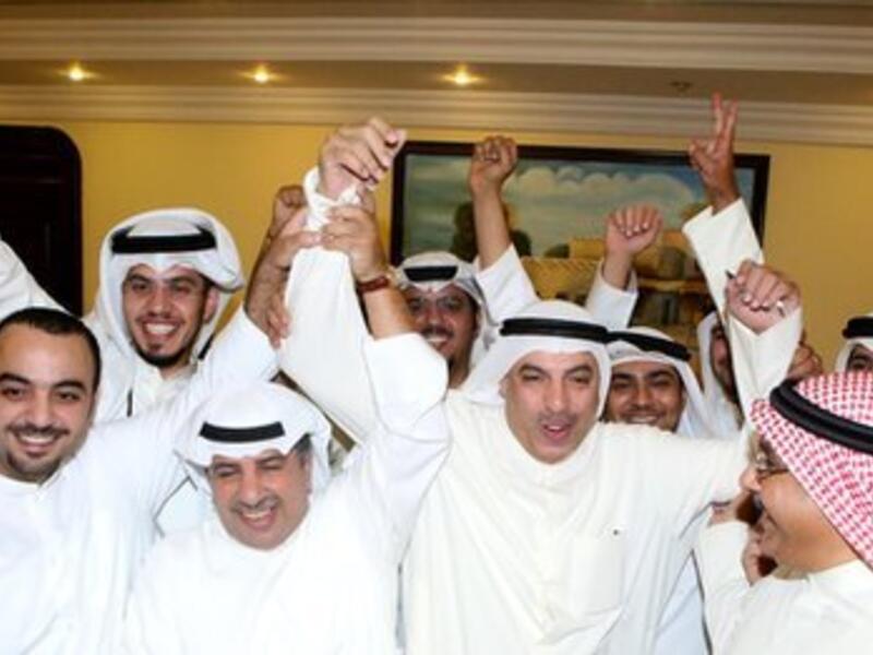 Liberals, who were not represented in the previous parliament, won three seats in the elections. Here, they celebrate in Kuwait City on Sunday morning. (AFP)