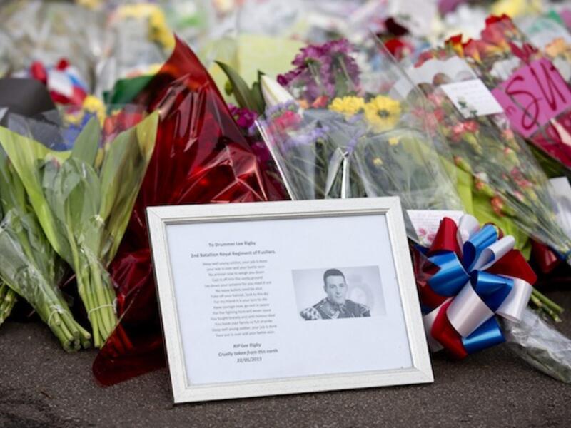 A framed photograph of Drummer Lee Rigby lies among flowers and tributes in Woolwich. AFP Photo