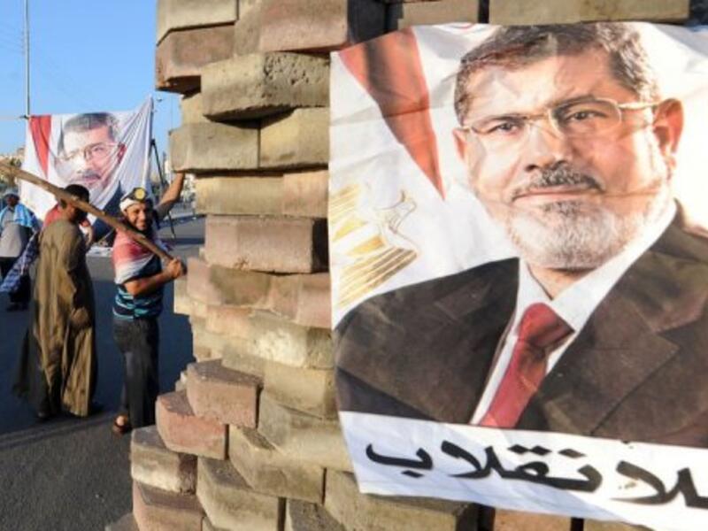 An image of deposed president Mohamed Morsi at a makeshift barricade on Nasr City's main street in Cairo, July 28, 2013 (AFP)