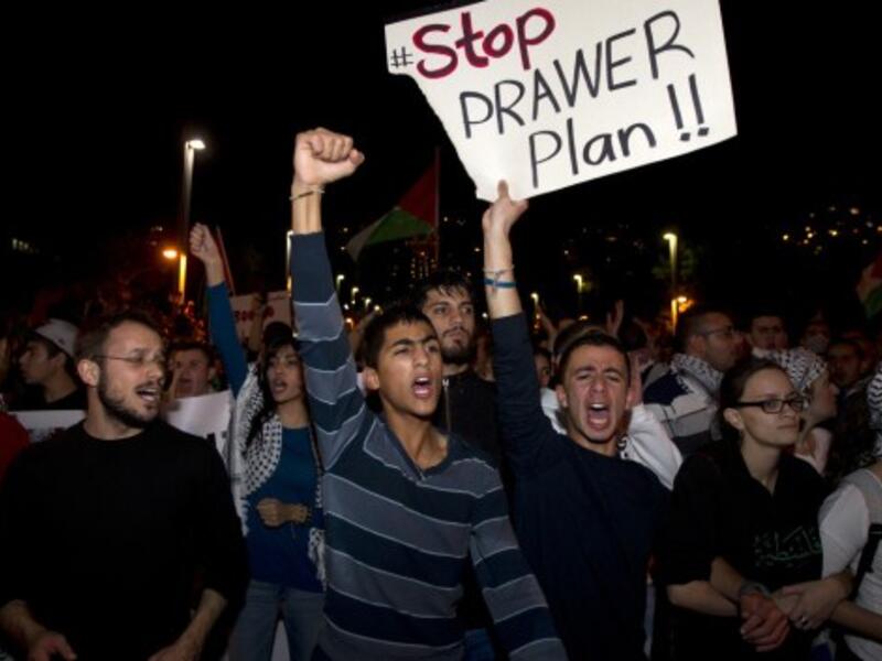 Arab-Israelis take part in a demonstration against the against the Prawer plan in the northern Israeli city of Haifa on November 30, 2013. The so-called Prawer-Begin Bill calls for the relocation of 30,000-40,000 Bedouin in the Negev - 80 percent of which support the law, according to Israeli official Dror Almog. (AFP)
