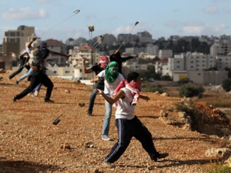 Palestinian protesters hurl rocks at Israeli soldiers during clashes in Betunia near the West Bank city of Ramallah on October 4, 2013. The Palestinian and Israeli delegations locked horns at the IPU meeting in Geneva on Wednesday. (AFP)
