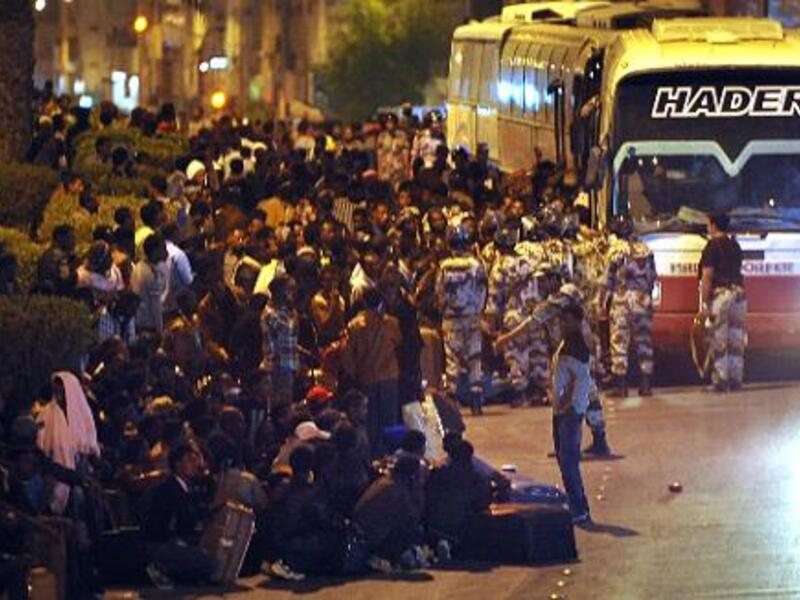 The Saudi Arabian government has deported more than 126,000 illegal workers in the one month since the authorities cracked down on migrants in the Kingdom. Here, Illegal migrants wait to be transferred by police buses to a deportation centre in Riyadh, on November 13, 2013 (AFP)