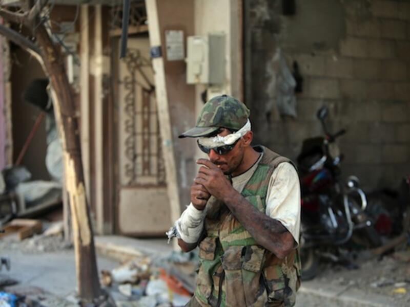 One Iranian Revolutionary Guard commander has criticised the "bad habits" of the Syrian army, who he says prefer smoking and drinking tea to fighting. (AFP/File)