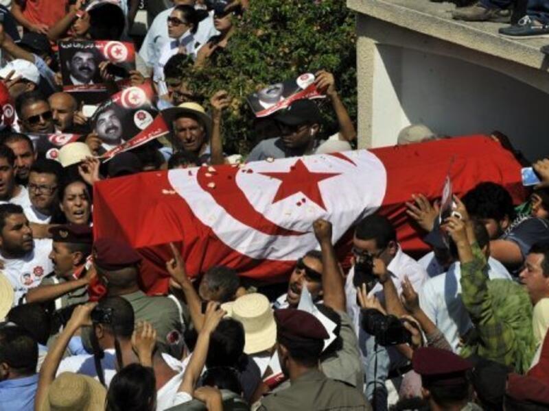 Tunisian mourners carry the coffin of assassinated opposition leader Mohamed Brahmi on Saturday. (AFP)