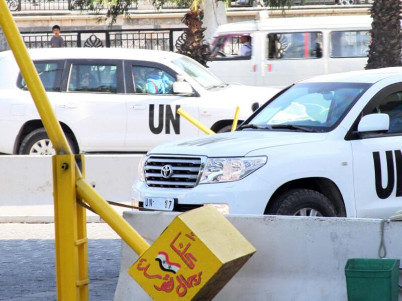 UN inspectors are seen arriving at the hotel in Damascus on August 26, 2013, following their return from an inspection of a suspected chemical weapons attack in Moadamiyet al-Sham. (AFP)