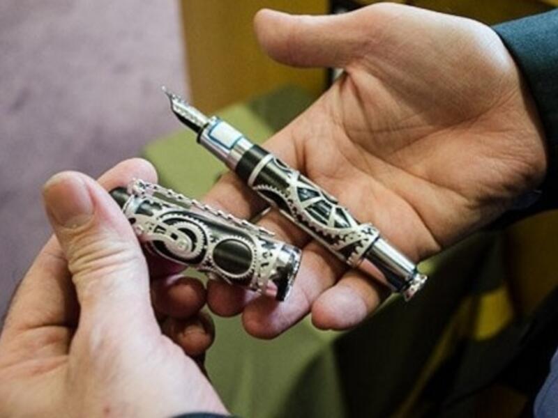 The president is using a Mont Blanc pen, which commemorates the life of Charlie Chaplin, to fund homes for the country’s war veterans and single mothers. (Image courtesy: Iran State News Agency)