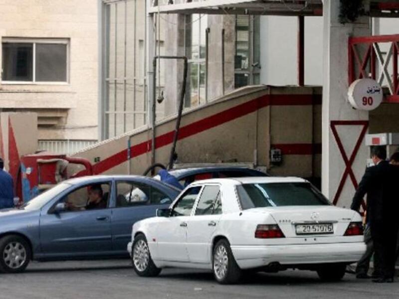 Motorists fill their cars with gasoline at a gas station in Amman on Saturday.