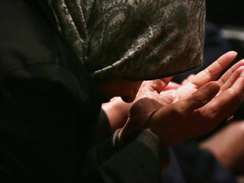 A Muslim woman prays during a Friday prayer service.  (AFP/Alex Wong)