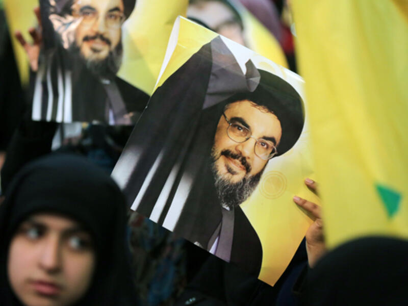 Hezbollah leader Hassan Nasrallah is seen on posters during a rally in Beirut. (AFP/File)