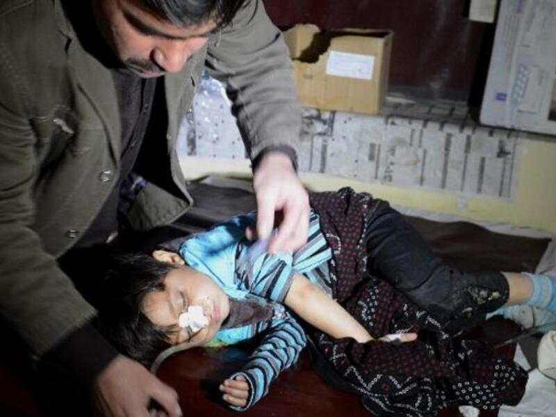 A Pakistani paramedic treats an injured child following a grenade attack on a polio vaccination team in Quetta. [AFP]