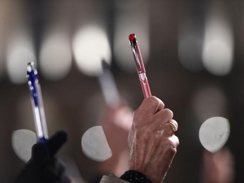 Demonstrators hold up pens in solidarity with last year's slain Charlie Hebdo journalists in France. (AFP/Damien Meyer)