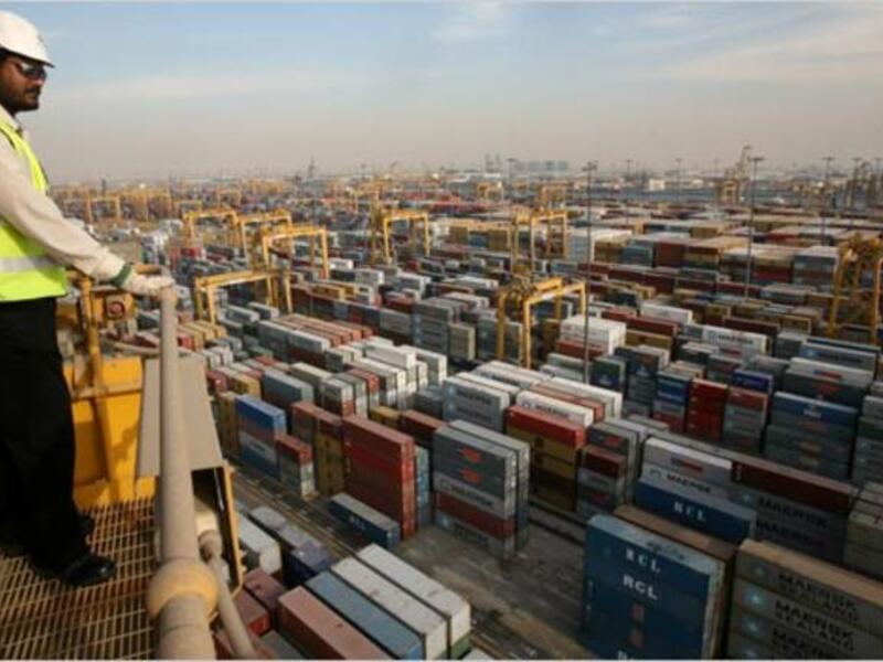 A safety inspector looks over containers alongside the Jebel Ali Free Zone in Dubai (Credit: The New York Times)