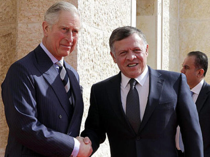 King Abdullah II greets the Prince of Wales outside Al Husseiniya Palace. (AFP/File)