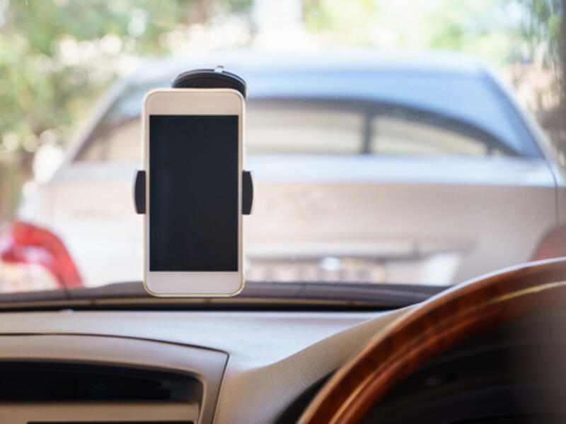 “Installation of a tool or a device to place the mobile phone or any other electronic device for the driver use will attract (a fine of) 15 rial with one black point,” according to the new law (Shutterstock/File)